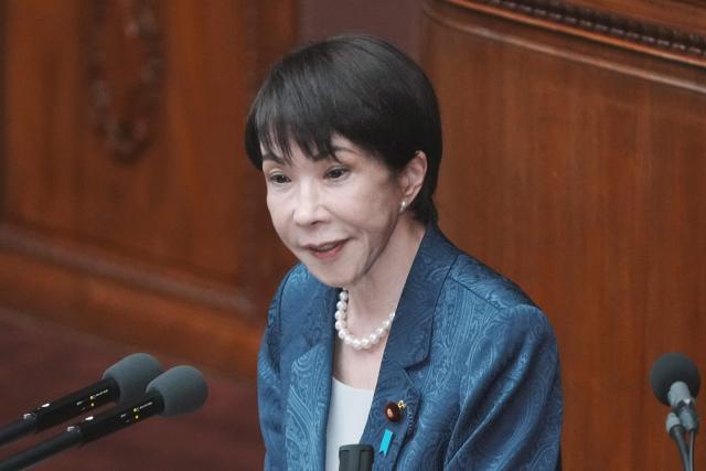 Japan's Prime Minister Sanae Takaichi answers questions from an opposition lawmaker regarding her report on the results of her recent visit to the United States during a plenary session of the House of Representatives at Parliament in Tokyo on March 26, 2026. (Photo by Kazuhiro NOGI / AFP)