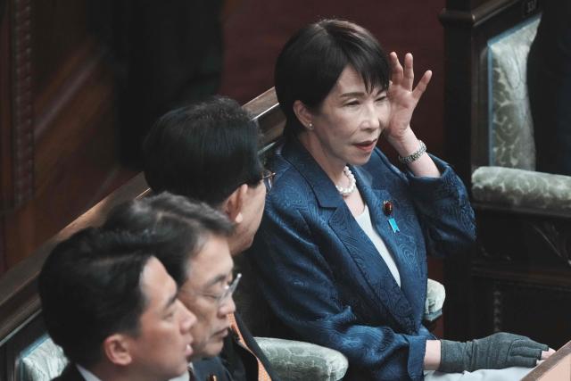 Japan's Prime Minister Sanae Takaichi (R) attends a plenary session of the House of Representatives at Parliament in Tokyo on March 26, 2026, to report on the results of her recent visit to the United States. (Photo by Kazuhiro NOGI / AFP)