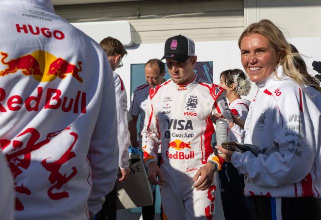 Racing Bulls` New Zealand driver Liam Lawson walks with members of his team ahead of the Formula 1 Japanese Grand Prix in Suzuka on March 26, 2026. (Photo by ANDREW CABALLERO-REYNOLDS / AFP)