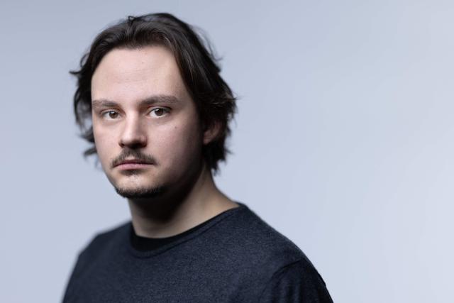 (FILES) French writer and poet Victor Malzac poses during a photo session in Paris on March 3, 2026. On stage, he stands, swaying his body from side to side, reciting his words and sometimes shouting: for Victor Malzac, one of the young writers shaking up the poetry scene in France, poems are meant to be read aloud. (Photo by Joel Saget / AFP)