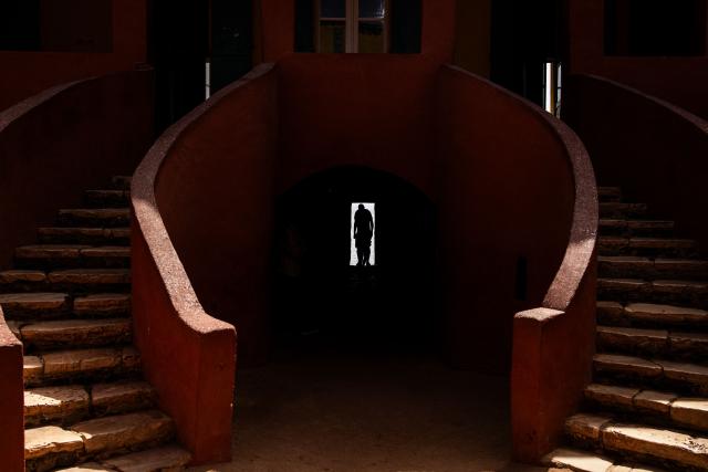 (FILES) A man stands in the Door of No Return at the memorial to the victims of the Atlantic slave trade on Goree Island in Dakar on May 8, 2024. The UN General Assembly on March 25, 2026 designated the transatlantic African slave trade as "the gravest crime against humanity," in a move advocates hailed as a step towards healing and possible reparations.
The resolution was adopted to applause by a vote of 123 in favor, three against -- the United States, Israel and Argentina -- and 52 abstentions, including Britain and member states of the European Union. (Photo by JOHN WESSELS / AFP)