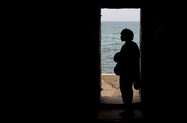 (FILES) A tourist looks out the Door of No Return in the House of Slaves, or Maison des Esclaves, at Goree Island off the coast of Dakar, Senegal, June 26, 2013. The UN General Assembly on March 25, 2026 designated the transatlantic African slave trade as "the gravest crime against humanity," in a move advocates hailed as a step towards healing and possible reparations.
The resolution was adopted to applause by a vote of 123 in favor, three against -- the United States, Israel and Argentina -- and 52 abstentions, including Britain and member states of the European Union. (Photo by Saul LOEB / AFP)