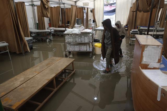 TOPSHOT - Floodwater covers the floor of an emergency field tent belonging to Nasser Hospital, which serves as the outpatient reception and emergency department, following heavy rain in Khan Yunis in the southern Gaza Strip on March 26, 2026. Violence has persisted in Gaza despite a ceasefire which came into effect on October 10, with both Israel and Hamas regularly accusing each other of violations. (Photo by Bashar Taleb / AFP)
