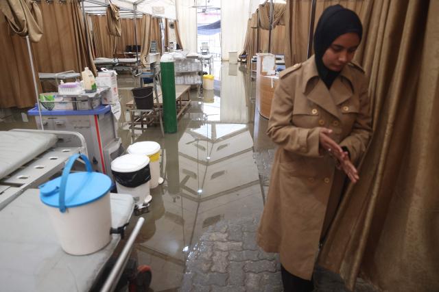 Floodwater covers the floor of an emergency field tent belonging to Nasser Hospital, which serves as the outpatient reception and emergency department, following heavy rain in Khan Yunis in the southern Gaza Strip on March 26, 2026. Violence has persisted in Gaza despite a ceasefire which came into effect on October 10, with both Israel and Hamas regularly accusing each other of violations. (Photo by Bashar Taleb / AFP)