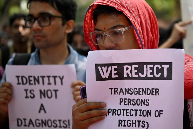 Supporters and members of the transgender community hold placards during a protest against the proposed Transgender Persons (Protection of Rights) Amendment Bill in New Delhi on March 26, 2026. (Photo by Arun SANKAR / AFP)