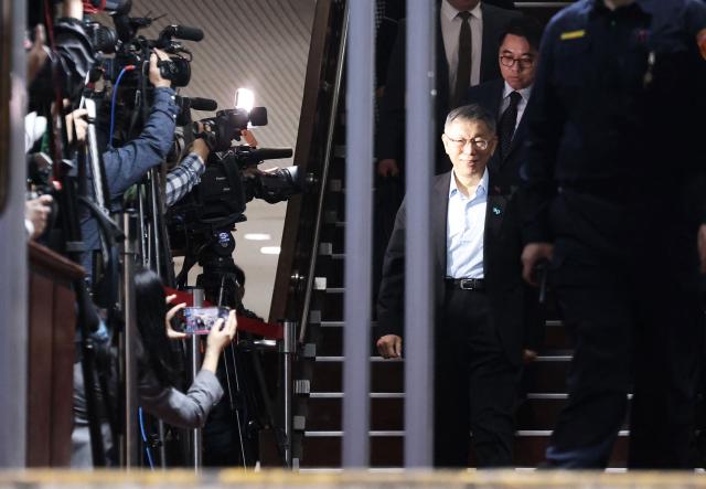 Former Taipei mayor and 2024 presidential candidate Ko Wen-je walks out of the Taipei District Court in Taipei on March 26, 2026. Ko, who once ran for the presidency, was sentenced on March 26, to 17 years in prison for taking bribes and misusing political donations. (Photo by I-Hwa Cheng / AFP)
