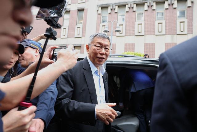 Taiwan’s former Taipei mayor and 2024 presidential candidate Ko Wen-je leaves the Taipei District Court in Taipei on March 26, 2026. Ko, who once ran for the presidency, was sentenced on March 26, to 17 years in prison for taking bribes and misusing political donations. (Photo by I-Hwa Cheng / AFP)