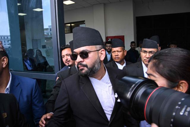 Rastriya Swatantra Party (RSP) leader Balendra Shah (C) arrives to take oath during a swearing-in ceremony at the parliament in Kathmandu on March 26, 2026. Four-time prime minister and Marxist leader Oli, 74, was defeated in the polls this month by the 35-year-old rapper-turned-politician Balendra Shah, whose Rastriya Swatantra Party (RSP) won in a landslide after promising to oust an ageing elite, stem corruption and fix the economy. (Photo by PRAKASH MATHEMA / AFP)
