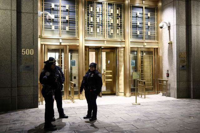Police officers patrol outside the Daniel Patrick Moynihan United States Courthouse as a convoy believed to be carrying ousted Venezuelan president Nicolas Maduro has arrived for his federal court appearance in Manhattan on March 26, 2026. Lawyers for the ousted Venezuelan president Nicolas Maduro are expected to push for the dismissal of his drug trafficking charges when he appears in a New York court March 26. The Manhattan hearing comes as Washington cautiously warms ties with Caracas, with the question of who will pay the legal fees of the former autocrat and his wife expected to take center stage. (Photo by CHARLY TRIBALLEAU / AFP)