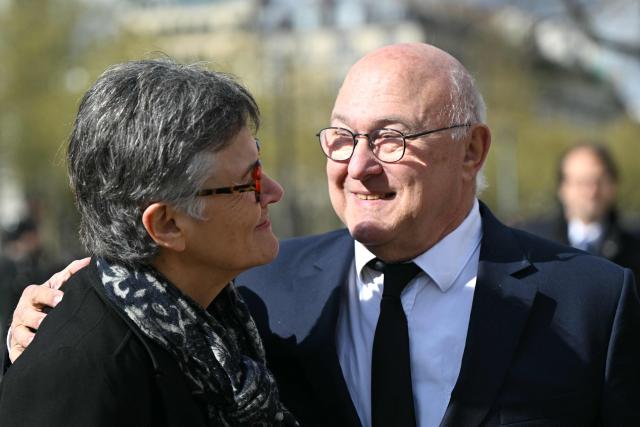 Former French Economy Minister Michel Sapin (R) greets Ecologiste et Social's MP Dominique Voynet as they arrive at a national tribute to former French Prime Minister Lionel Jospin at the Hotel des Invalides in Paris on March 26, 2026. Born on July 12, 1937, former French prime minister Lionel Jospin, a Socialist who introduced the 35-hour work week and civil partnerships for gay couples, has died aged 88, his family said on March 23, 2026. (Photo by Bertrand GUAY / AFP)