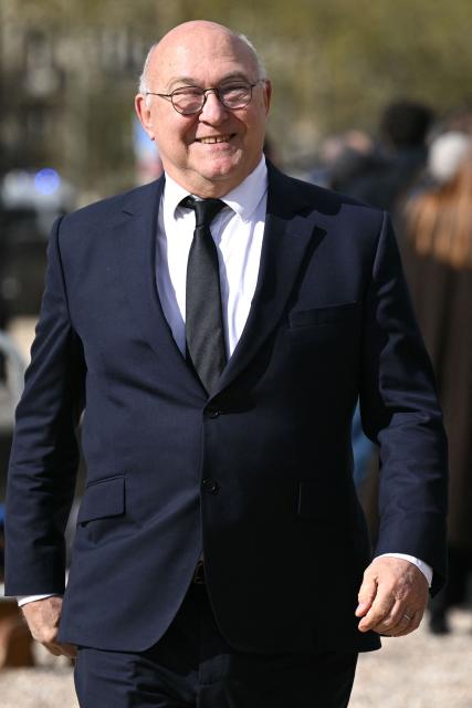 former French Economy Minister Michel Sapin arrives at a national tribute to former French Prime Minister Lionel Jospin at the Hotel des Invalides in Paris on March 26, 2026. Born on July 12, 1937, former French prime minister Lionel Jospin, a Socialist who introduced the 35-hour work week and civil partnerships for gay couples, has died aged 88, his family said on March 23, 2026. (Photo by Bertrand GUAY / AFP)