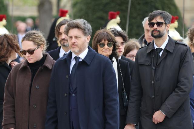 Wife of Lionel Jospin, French philosopher Sylviane Agacinski (C) and relatives follow the coffin at the end of a national tribute to former French Prime Minister Lionel Jospin at the Hotel des Invalides in Paris on March 26, 2026. Born on July 12, 1937, former French prime minister Lionel Jospin, a Socialist who introduced the 35-hour work week and civil partnerships for gay couples, has died aged 88, his family said on March 23, 2026. (Photo by Ludovic MARIN / POOL / AFP)