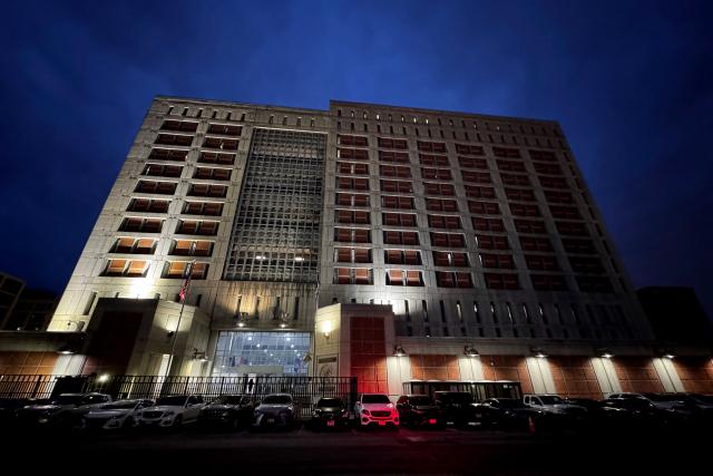 An exterior view of the Metropolitan Detention Center is seen in the Brooklyn borough of New York City, where ousted Venezuelan president Nicolas Maduro is detained, ahead of his court appearance later in the day, on March 26, 2026. Lawyers for the ousted Venezuelan president Nicolas Maduro are expected to push for the dismissal of his drug trafficking charges when he appears in a New York court March 26. The Manhattan hearing comes as Washington cautiously warms ties with Caracas, with the question of who will pay the legal fees of the former autocrat and his wife expected to take center stage. (Photo by Leonardo MUNOZ / AFP)