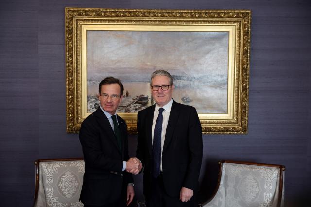 British Prime Minister Keir Starmer (R) shakes hands with Swedish Prime Minister Ulf Kristersson during a bilateral meeting at the Joint Expeditionary Force JEF Leaders’ Summit in Helsinki, Finland on March 26, 2026. (Photo by Adrian Dennis / POOL / AFP)