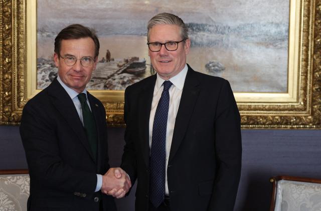 British Prime Minister Keir Starmer (R) shakes hands with Swedish Prime Minister Ulf Kristersson during a bilateral meeting at the Joint Expeditionary Force JEF Leaders’ Summit in Helsinki, Finland on March 26, 2026. (Photo by Adrian Dennis / POOL / AFP)