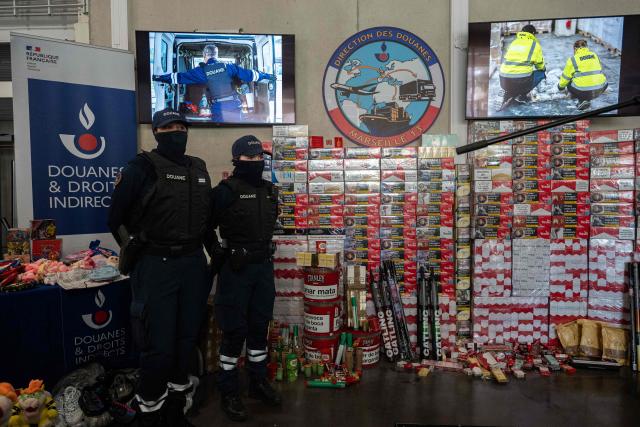 Marseille customs officers stand next to counterfeit goods seized at the port of Marseille during the presentation of the 2025 results by the Marseille customs directorate, in Marseille, on March, 26, 2026. (Photo by Elodie CLEMENT / AFP)