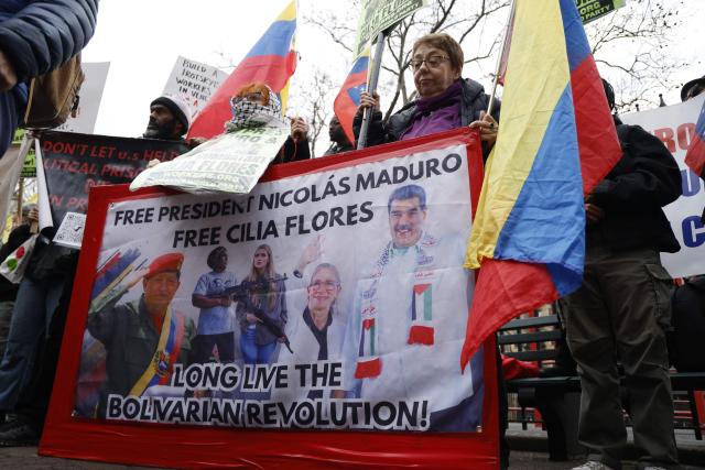 Supporters of ousted Venezuelan president Nicolas Maduro protest outside the Daniel Patrick Moynihan United States Courthouse in New York City on March 26, 2026. Lawyers for the ousted Venezuelan president Nicolas Maduro are expected to push for the dismissal of his drug trafficking charges when he appears in a New York court March 26. The Manhattan hearing comes as Washington cautiously warms ties with Caracas, with the question of who will pay the legal fees of the former autocrat and his wife expected to take center stage. (Photo by John Lamparski / AFP)