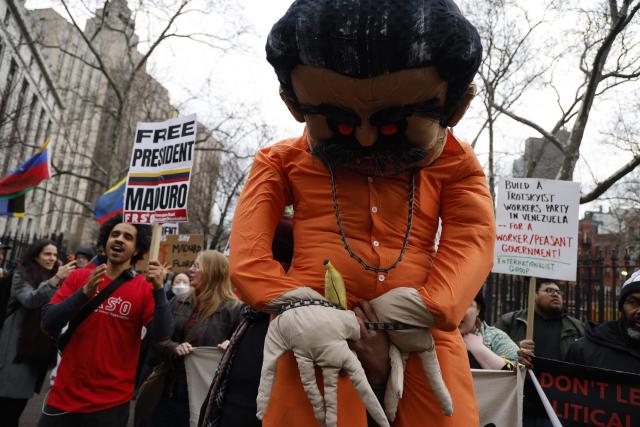 Supporters of ousted Venezuelan president Nicolas Maduro protest outside the Daniel Patrick Moynihan United States Courthouse in New York City on March 26, 2026. Lawyers for the ousted Venezuelan president Nicolas Maduro are expected to push for the dismissal of his drug trafficking charges when he appears in a New York court March 26. The Manhattan hearing comes as Washington cautiously warms ties with Caracas, with the question of who will pay the legal fees of the former autocrat and his wife expected to take center stage. (Photo by John Lamparski / AFP)