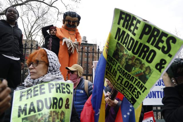 Supporters of ousted Venezuelan president Nicolas Maduro protest outside the Daniel Patrick Moynihan United States Courthouse in New York City on March 26, 2026. Lawyers for the ousted Venezuelan president Nicolas Maduro are expected to push for the dismissal of his drug trafficking charges when he appears in a New York court March 26. The Manhattan hearing comes as Washington cautiously warms ties with Caracas, with the question of who will pay the legal fees of the former autocrat and his wife expected to take center stage. (Photo by John Lamparski / AFP)