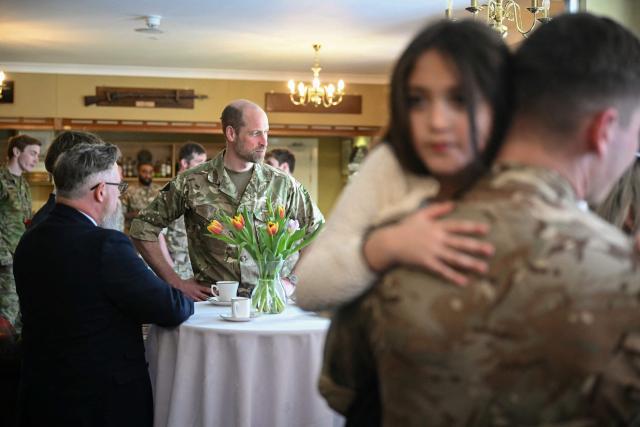 Britain's Prince William (2nd L), Prince of Wales as Colonel-in-Chief of the Regiment, meets with soldiers of the 1st Battalion Mercian Regiment and family members following their six-month deployment to Estonia, in Bulford in south-west England on March 26, 2026. (Photo by JUSTIN TALLIS / POOL / AFP)