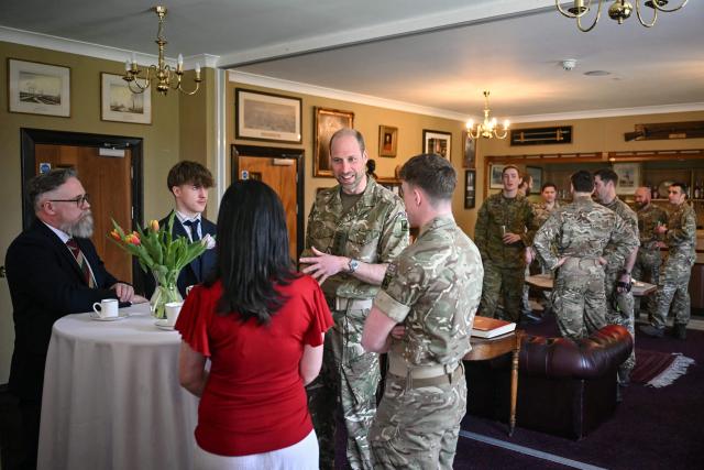 Britain's Prince William (C), Prince of Wales as Colonel-in-Chief of the Regiment, meets with soldiers of the 1st Battalion Mercian Regiment and family members following their six-month deployment to Estonia, in Bulford in south-west England on March 26, 2026. (Photo by JUSTIN TALLIS / POOL / AFP)