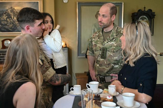 Britain's Prince William (2nd R), Prince of Wales as Colonel-in-Chief of the Regiment, meets with soldiers of the 1st Battalion Mercian Regiment and family members following their six-month deployment to Estonia, in Bulford in south-west England on March 26, 2026. (Photo by JUSTIN TALLIS / POOL / AFP)
