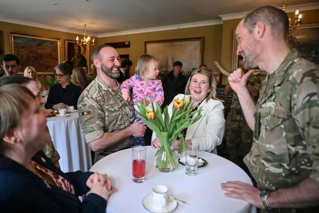 Britain's Prince William (R), Prince of Wales as Colonel-in-Chief of the Regiment, meets with soldiers of the 1st Battalion Mercian Regiment and family members following their six-month deployment to Estonia, in Bulford in south-west England on March 26, 2026. (Photo by JUSTIN TALLIS / POOL / AFP)