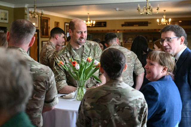 Britain's Prince William (C), Prince of Wales as Colonel-in-Chief of the Regiment, meets with soldiers of the 1st Battalion Mercian Regiment and family members following their six-month deployment to Estonia, in Bulford in south-west England on March 26, 2026. (Photo by JUSTIN TALLIS / POOL / AFP)