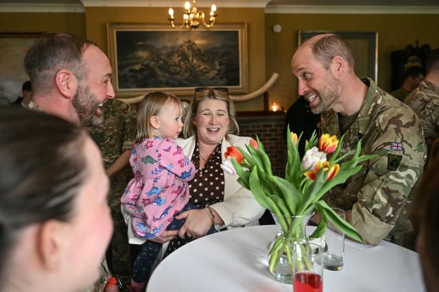 Britain's Prince William (R), Prince of Wales as Colonel-in-Chief of the Regiment, meets with soldiers of the 1st Battalion Mercian Regiment and family members following their six-month deployment to Estonia, in Bulford in south-west England on March 26, 2026. (Photo by JUSTIN TALLIS / POOL / AFP)