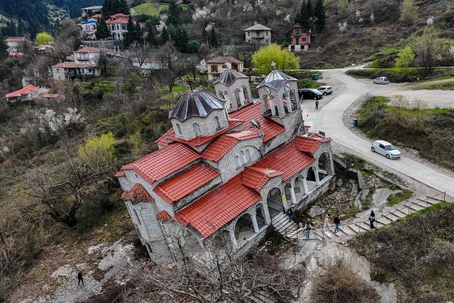 Aerial view shows the Greek Orthodox Church of the Dormition of the Virgin Mary, after a massive landslide in April 2012 moved the entire structure several metres downhill where it rested tilted at 17 degrees, in the village of Ropoto, central Greece, on March 22, 2026. (Photo by Will VASSILOPOULOS / AFP)