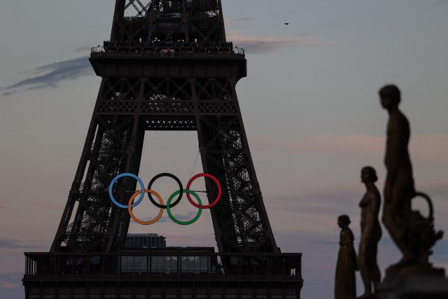 (FILES) This general view from Place du Trocadero shows the Olympic rings on The Eiffel Tower in Paris on September 6, 2024. The International Olympic Committee (IOC) said on March 26, 2026, that it was re-introducing genetic testing for gender to determine eligibility for "any female category event", beginning with the 2028 Los Angeles Games. (Photo by Thibaud MORITZ / AFP)