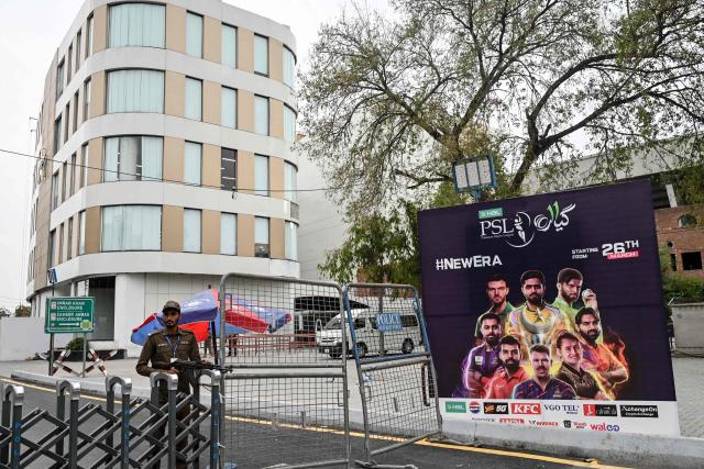 A security personnel stands guard outside Gaddafi Cricket Stadium in Lahore on March 26, 2026 before the start of the Twenty20 cricket match between Lahore Qalandars and Hyderabad Kingsmen.  (Photo by Arif ALI / AFP)
