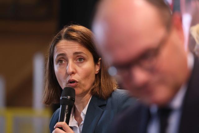 French trade union General Confederation of Labour (CGT) Secretary General Sophie Binet (L) and France’s junior Minister for Industry Sebastien Martin (R) take part in a debate during the CGT ‘Made in France’ conference in Pont-de-Claix, central-eastern France, on March 26, 2026. (Photo by Alex MARTIN / AFP)