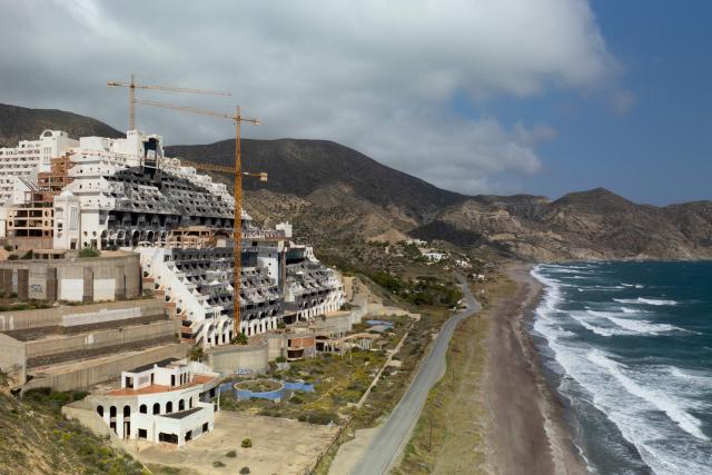 The unfinished Algarrobico Hotel inside Cabo de Gata Natural Park is seen in this aerial view in Carboneras, near Almeria on March 26, 2026. (Photo by JORGE GUERRERO / AFP)