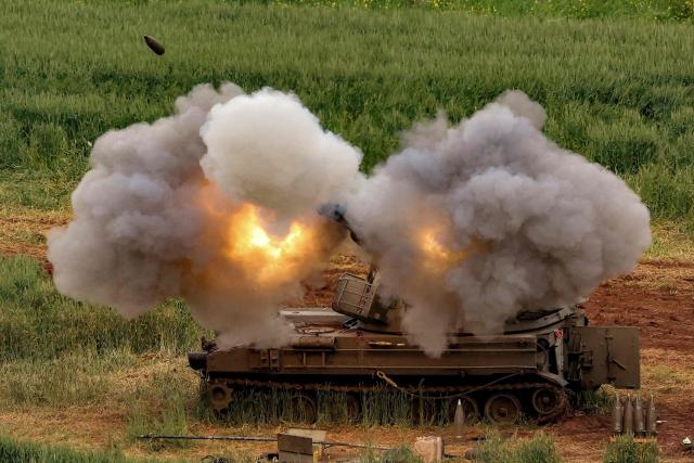 TOPSHOT - An Israeli self-propelled howitzer artillery gun fires rounds towards southern Lebanon from a position in the upper Galilee in northern Israel near the border on March 26, 2026. Lebanon was drawn into the Middle East war on March 2, when pro-Iran Hezbollah launched rockets towards Israel in response to US-Israeli strikes that killed Iranian supreme leader on February 28. (Photo by Jack GUEZ / AFP) / 