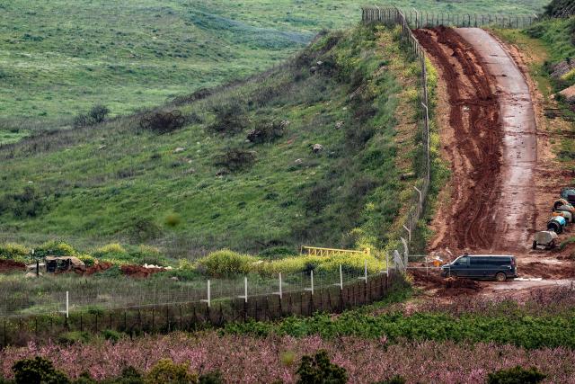 Israeli military vehicles move along a road in southern Lebanon close to the Israeli border on March 26, 2026. Lebanon was drawn into the Middle East war on March 2, when pro-Iran Hezbollah launched rockets towards Israel in response to US-Israeli strikes that killed Iranian supreme leader on February 28. (Photo by Jack GUEZ / AFP) / 