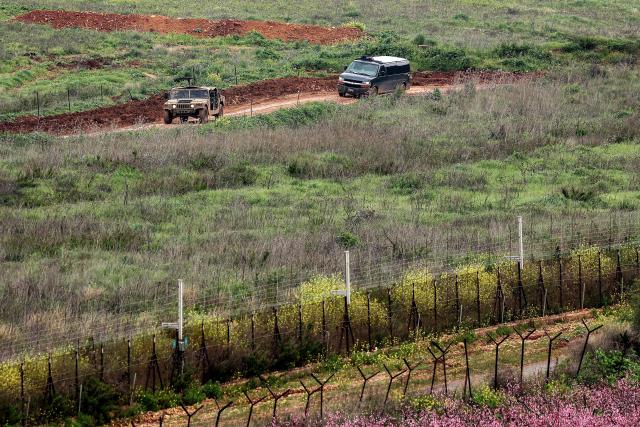Israeli military vehicles move along a road in southern Lebanon close to the Israeli border on March 26, 2026. Lebanon was drawn into the Middle East war on March 2, when pro-Iran Hezbollah launched rockets towards Israel in response to US-Israeli strikes that killed Iranian supreme leader on February 28. (Photo by Jack GUEZ / AFP) / 
