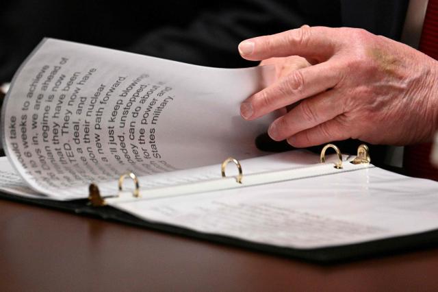 US President Donald Trump reads a statement during a cabinet meeting in the Cabinet Room of the White House in Washington, DC, on March 26, 2026. (Photo by Jim WATSON / AFP)
