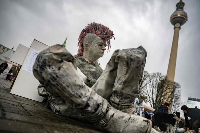 A mannequin representing a homeless man is placed in front of the Berlin Town Hall (Rotes Rathaus) during a demonstration to call attention to the plight of homeless and evicted persons in the German capital, on March 26, 2026. (Photo by John MACDOUGALL / AFP)