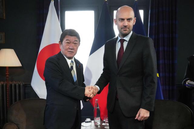 Japan's Foreign Affairs Minister Toshimitsu Motegi (L) shakes hands with France's Foreign Affairs Minister Jean-Noel Barrot during a bilateral meeting on the sidelines of the G7 Foreign Ministers' meeting with Partner Countries at the Vaux-de-Cernay Abbey in Cernay-la-Ville outside Paris, on March 26, 2026. Foreign ministers from the G7 will take part part in a two-day meeting with European nations and allies seeking to narrow differences with the US on the Middle East war while keeping other crises like Ukraine and Gaza high on the agenda. (Photo by Michel Euler / POOL / AFP)