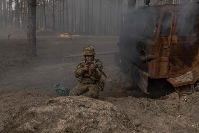 A Ukrainian recruit runs as he completes a basic military training at the Ukrainian Ground Forces training center in an undisclosed location on March 25, 2026, amid the Russian invasion of Ukraine. (Photo by Roman PILIPEY / AFP)