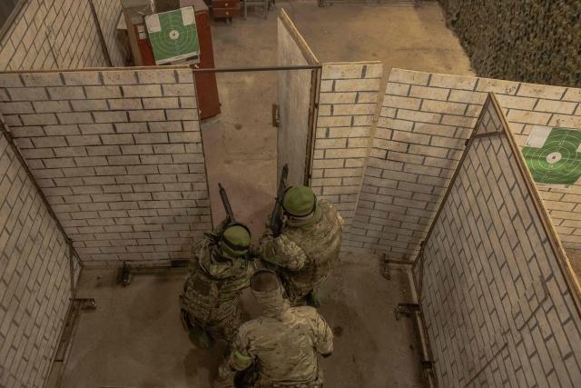 Ukrainian recruits complete basic military training at the Ukrainian Ground Forces training center in an undisclosed location on March 25, 2026, amid the Russian invasion of Ukraine. (Photo by Roman PILIPEY / AFP)