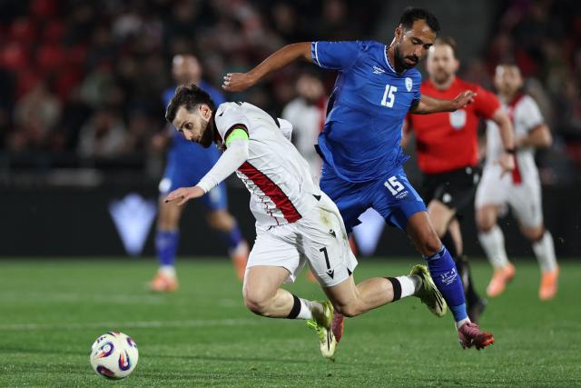 Israel's midfielder Eliel Peretz fouls Georgia's forward #07 Khvicha Kvaratskhelia during the friendly football match between Georgia and Israel in Tbilisi on March 26, 2026. (Photo by Giorgi ARJEVANIDZE / AFP)
