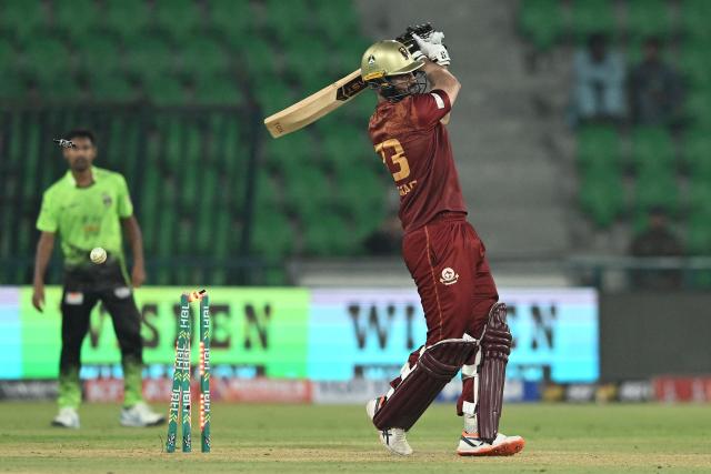Hyderabad Kingsmen's Pakistani all-rounder Hammad Azam (R) is clean bowled by Lahore Qalandars' Pakistani bowler Ubaid Shah (not pictured) during the Pakistan Super League (PSL) Twenty20 match between Lahore Qalandars and Hyderabad Kingsmen at Gaddafi Stadium in Lahore on March 26, 2026. (Photo by Arif ALI / AFP)
