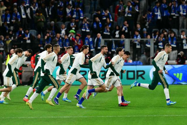 Italian players warm up before the play-off FIFA World Cup 2026 European qualification semi-final football match between Italy and North Ireland at the Gewiss stadium in Bergamo, on March 26, 2026. (Photo by Stefano RELLANDINI / AFP)