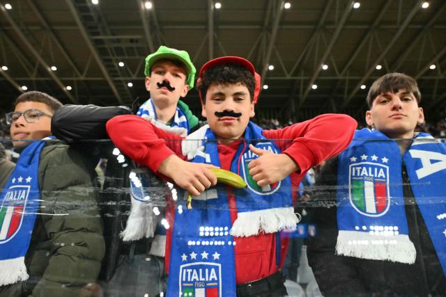 Italy's supporters pose before the play-off FIFA World Cup 2026 European qualification semi-final football match between Italy and North Ireland at the Gewiss stadium in Bergamo, on March 26, 2026. (Photo by Alberto PIZZOLI / AFP)