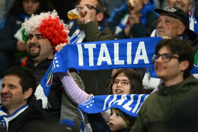 Supporters of Italy are pictured before the play-off FIFA World Cup 2026 European qualification semi-final football match between Italy and North Ireland at the Gewiss stadium in Bergamo, on March 26, 2026. (Photo by Alberto PIZZOLI / AFP)