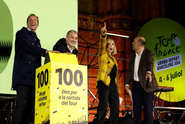 Tour de France General Director Christian Prudhomme (L) and Mayor of Barcelona Jaume Collboni (2L) activate of the 100-day countdown clock during 100-Day Grand Depart Tour de France 2026 celebration, on March 26, 2026, in Barcelona. Barcelona today kicks off the 100-day countdown to the Tour de France 2026 which will start in this town on July 4, 2026. (Photo by Lluis GENE / AFP)