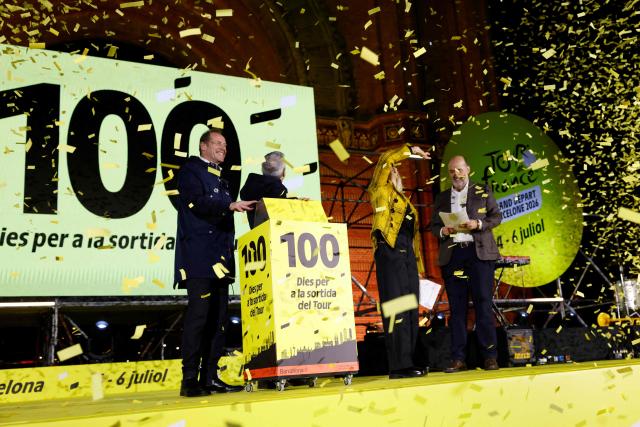 Tour de France General Director Christian Prudhomme (L) and Mayor of Barcelona Jaume Collboni (2L) activate of the 100-day countdown clock during 100-Day Grand Depart Tour de France 2026 celebration, on March 26, 2026, in Barcelona. Barcelona today kicks off the 100-day countdown to the Tour de France 2026 which will start in this town on July 4, 2026. (Photo by Lluis GENE / AFP)