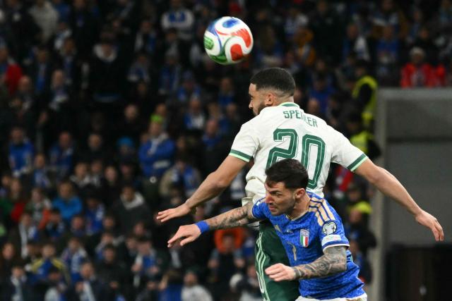 Northern Ireland's defender #20 Brodie Spencer fights for the ball with Italy's forward #07 Matteo Politano during the play-off FIFA World Cup 2026 European qualification semi-final football match between Italy and North Ireland at the Gewiss stadium in Bergamo, on March 26, 2026. (Photo by Alberto PIZZOLI / AFP)